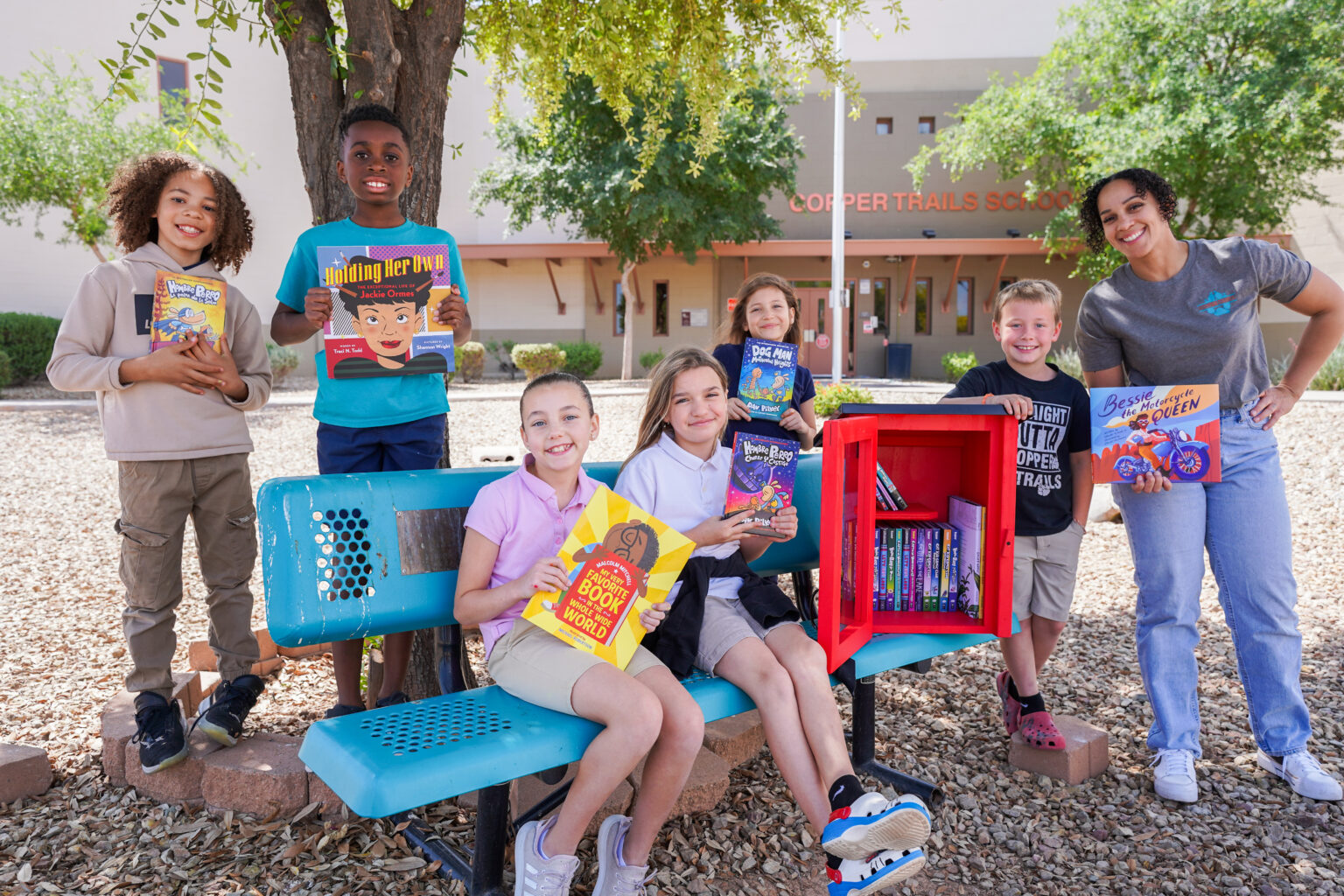 Little Free Library targets ‘book deserts’ with national expansion with beloved author’s help Children holding books by library box