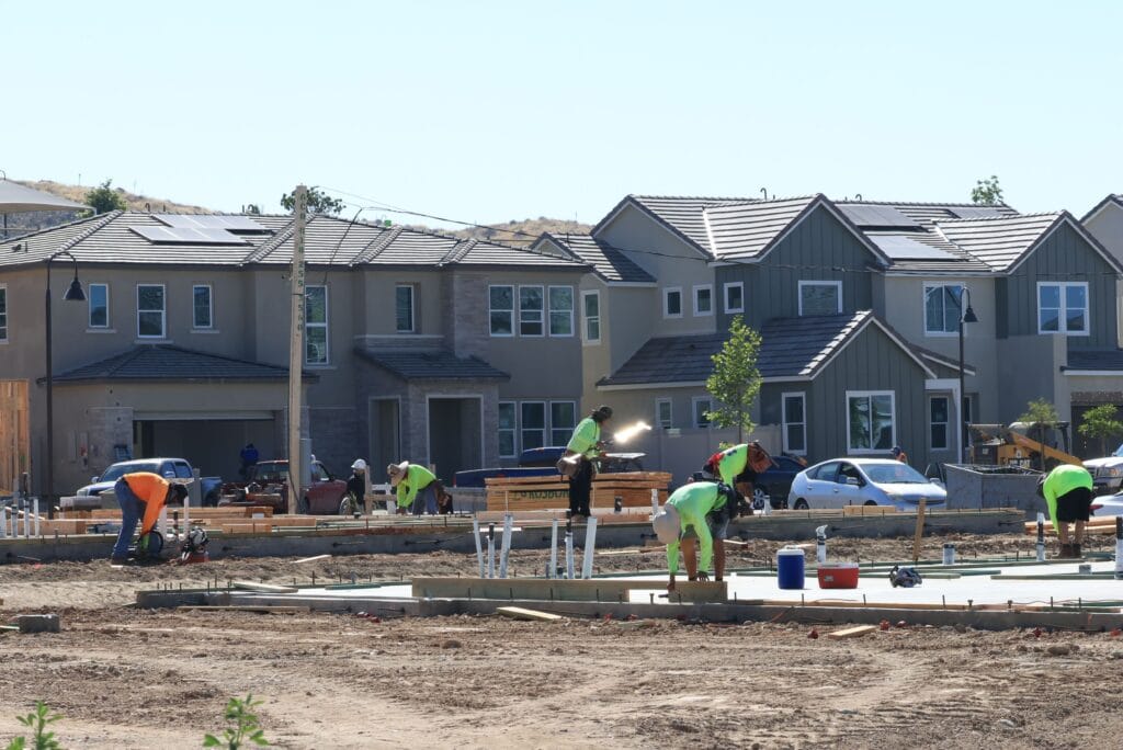 Construction workers lay down a foundation at a home development in this June 2023 photo. New analysis from Zillow shows building more homes in 2024 eased the housing crisis. (Pexels.com)