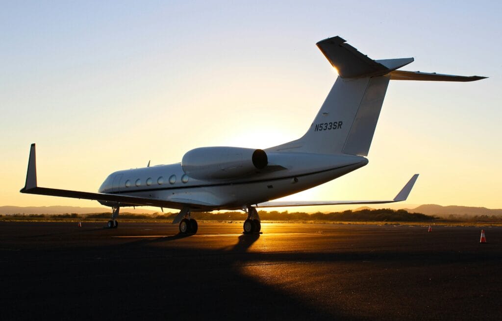 A private jet is seen with the sunsetting in the background in this undated image from Unsplash.com; The FAA says an unqualified pilot flew several charter flights in April 2025.