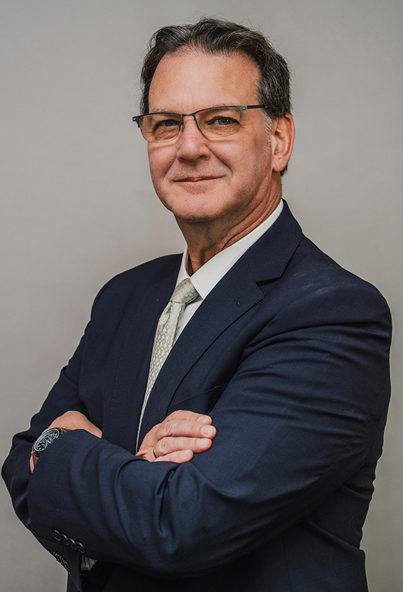 Amtrak Interim President Byl Herrmann, who commented on the Spain train crash, in a navy suit with arms crossed