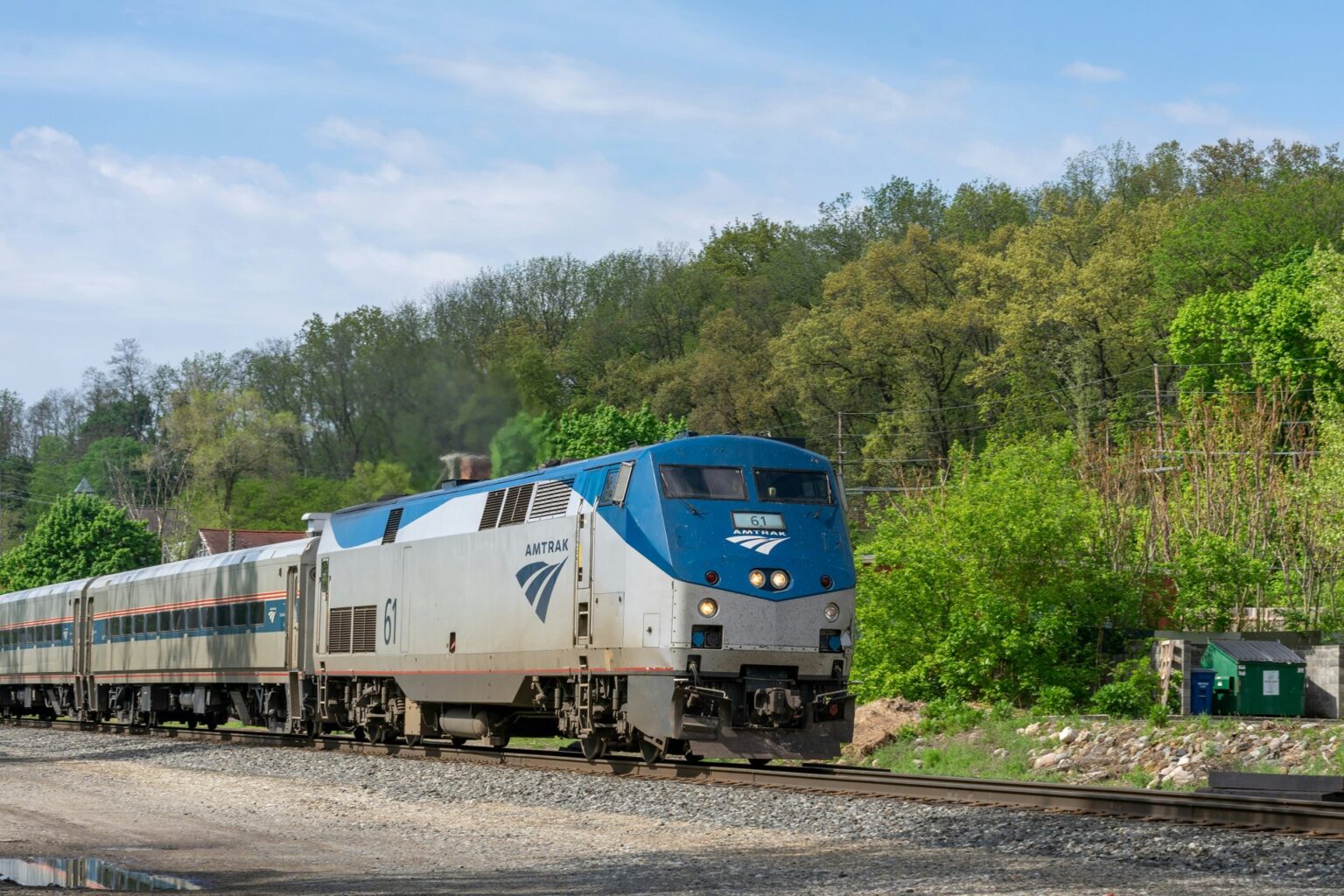 Amtrak extends condolences in wake of deadly high-speed rail crash in Spain An Amtrak locomotive pulls a passenger train past a wooded hillside in Ann Arbor, Michigan